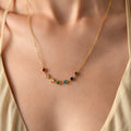 Personalised family heart birthstone necklace in gold vermeil, with seven colourful heart-shaped stones.