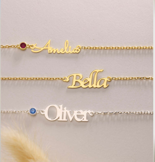 Three name necklaces showing different lettering and birthstone examples