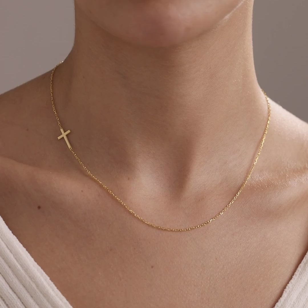 14K gold vermeil sideways cross necklace worn on a model