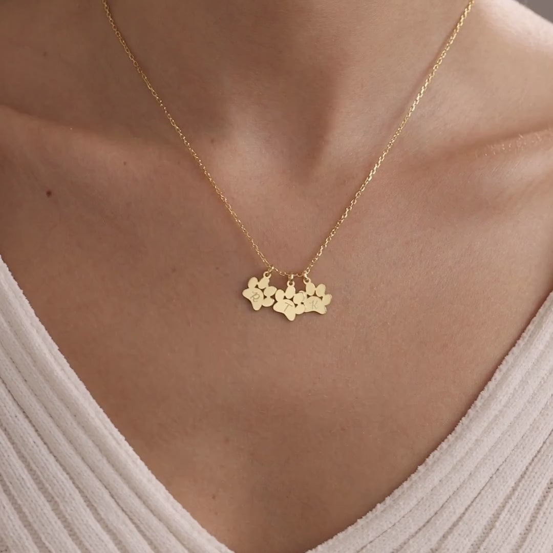 Personalised gold pet paw charm necklace worn on a model