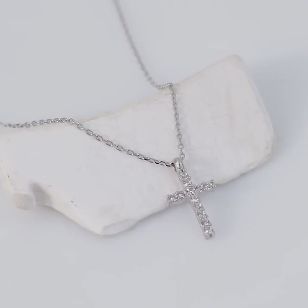 Tiny stone-set cross necklace: sterling silver close-up first, followed by gold vermeil worn on a model
