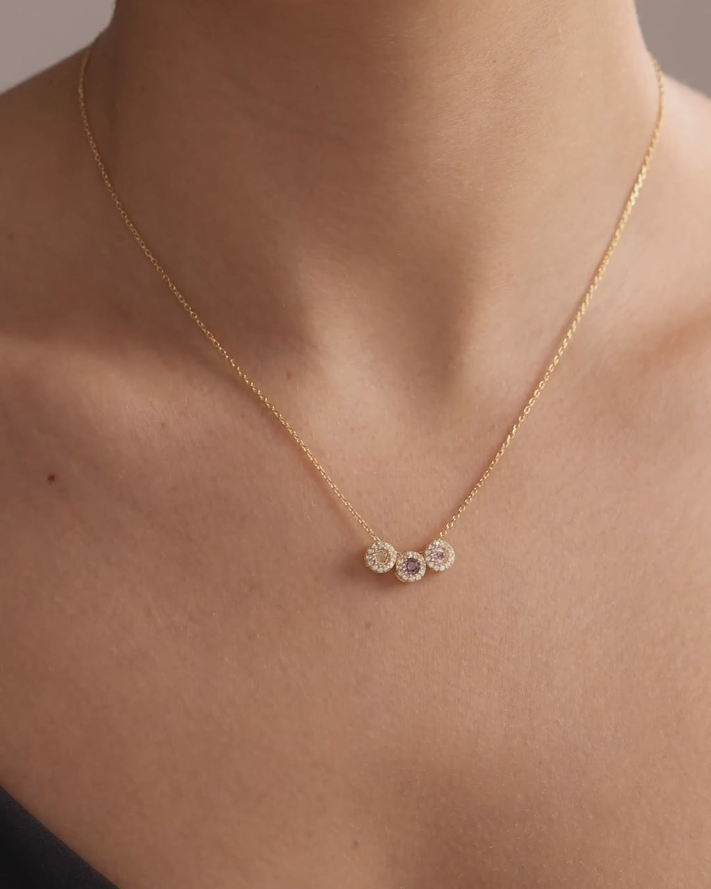 Round halo family birthstone necklace in gold vermeil, showing natural movement and scale when worn