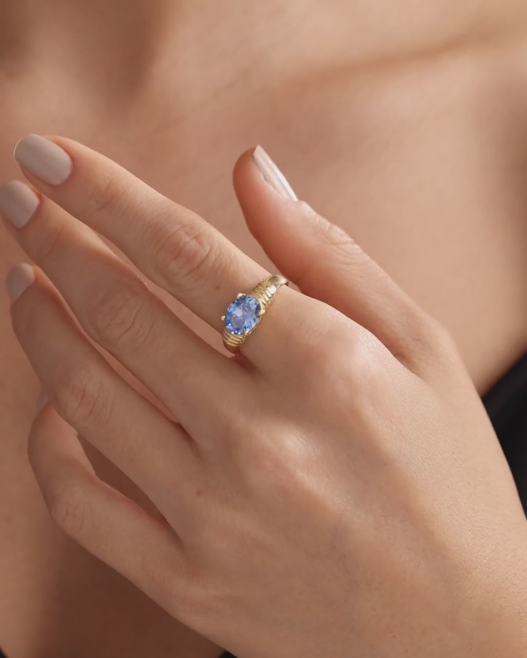 Oval blue birthstone ring in gold vermeil worn on a hand, showing its setting and scale from different angles