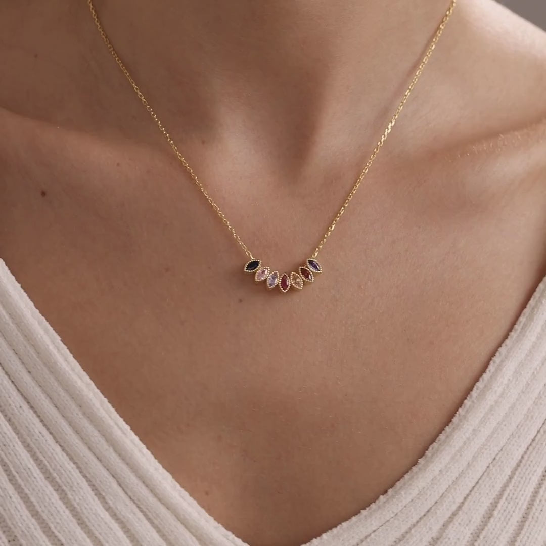 Marquise family birthstone necklace worn at the neckline, shown first in gold vermeil and then in sterling silver.
