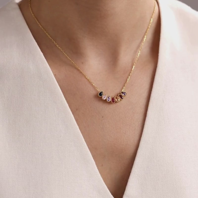 Teardrop family birthstone necklace in gold vermeil, showing natural movement and scale when worn