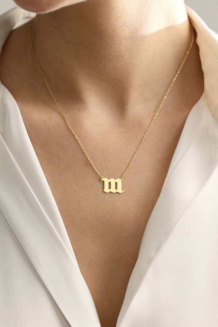 Sterling Silver Angel Number Necklace in a gold vermeil finish, showing the 111 design worn and the 444 pendant held close up.