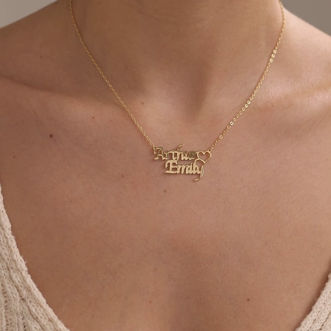 Personalised double name necklace with a heart, showing stacked Arthur and Emily names in a gold finish and William and Jessica names in a silver finish.