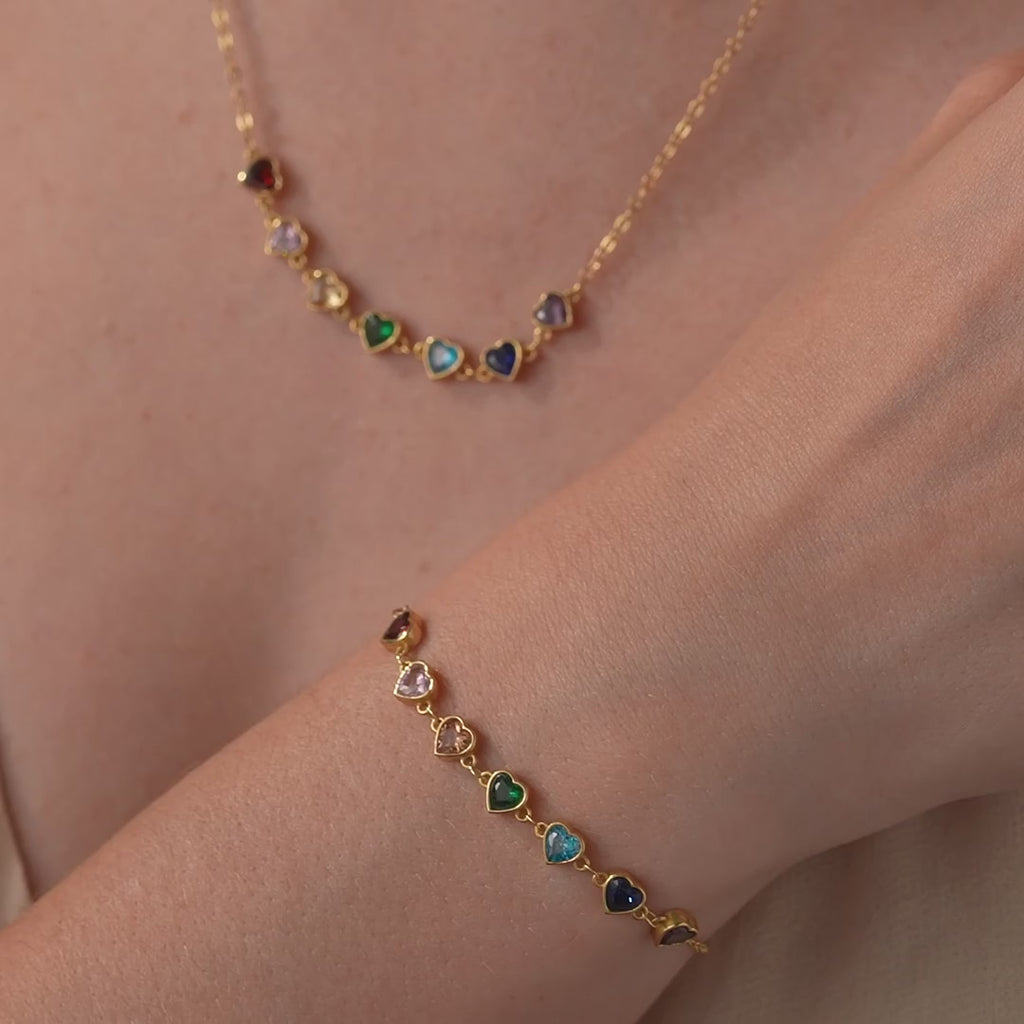 Gold vermeil heart birthstone bracelet worn on the wrist, followed by the coordinating necklace shown for styling.