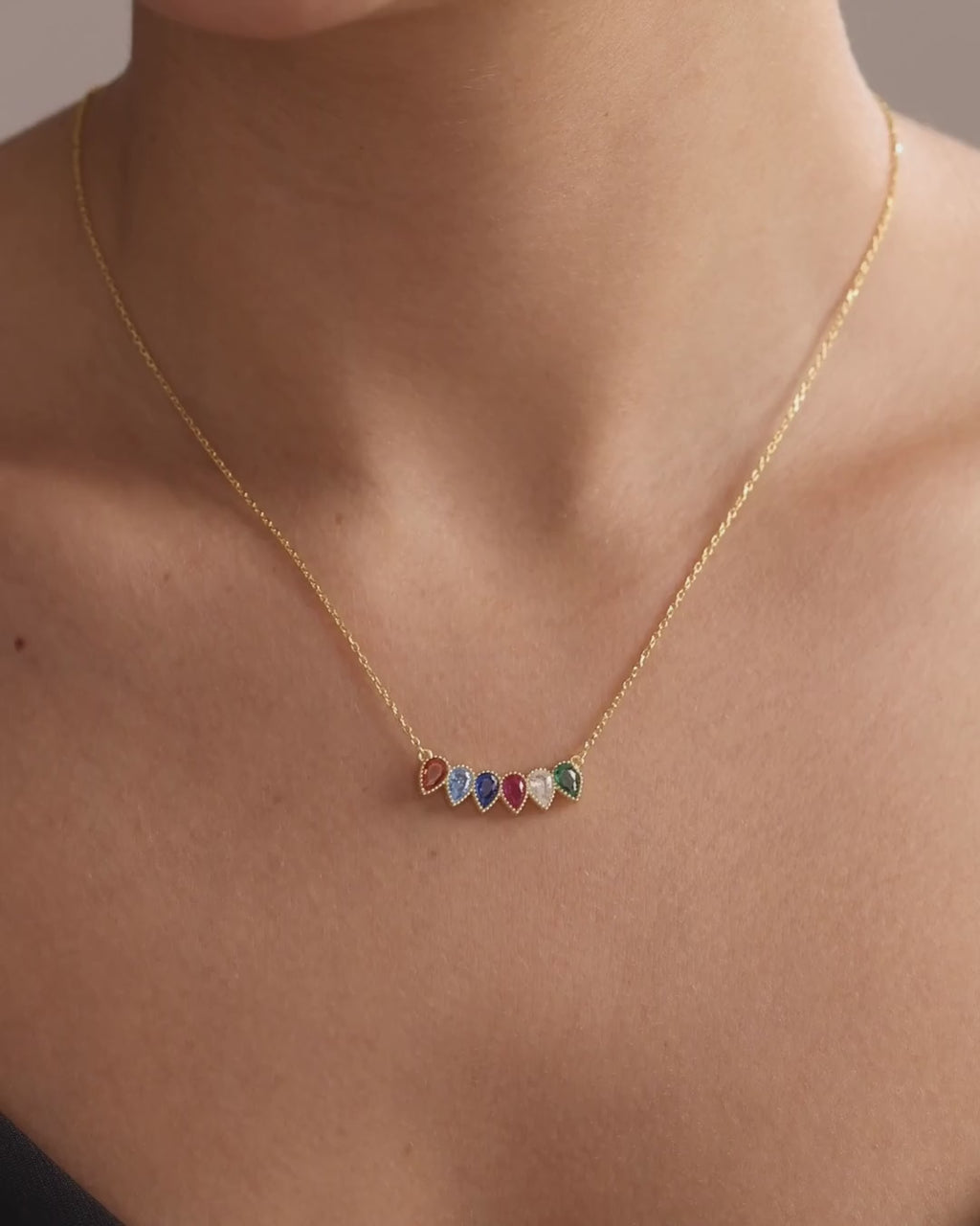 Fixed teardrop family birthstone necklace in gold vermeil, showing the coloured stones and scale when worn