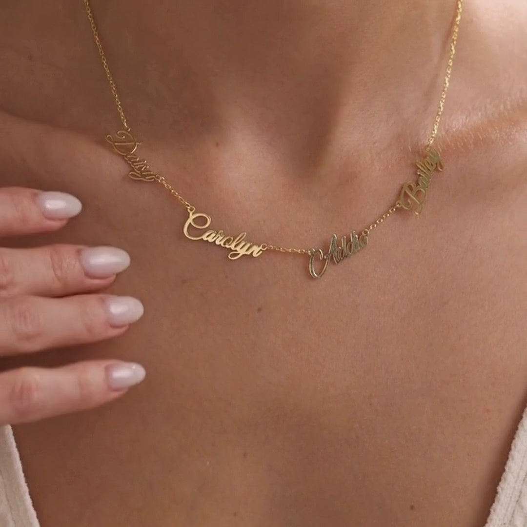 Personalised multiple name necklace in gold vermeil, showing a multi-name design first and a two-name necklace with a central heart second, worn at the neckline.